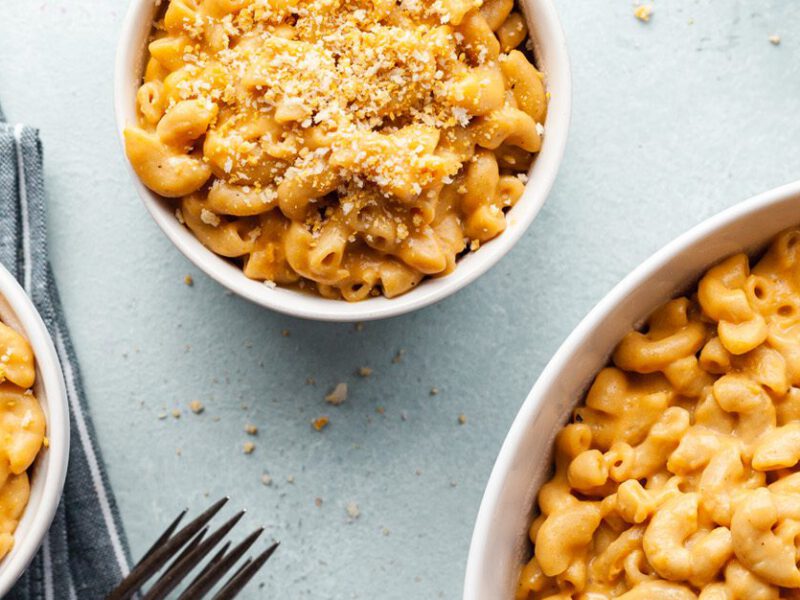 Vegan Instant Pot Mac and Cheese - cheesy mac shown in three bowls, sprinkled with bread crumbs