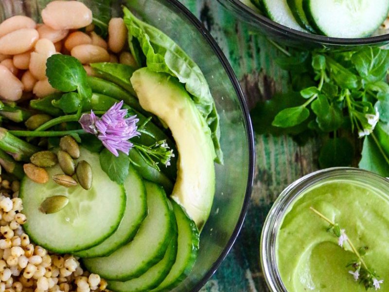Green Goddess Grain Bowl with cucumber, asparagus, white beans and sorghum and a small dish of Green Goddess Dressing