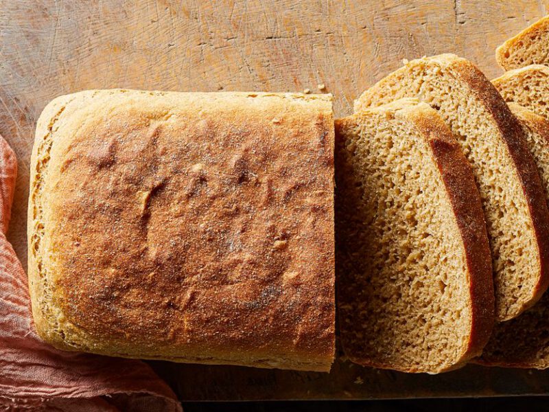 Vegan Potato Bread cut into slices on a wood board