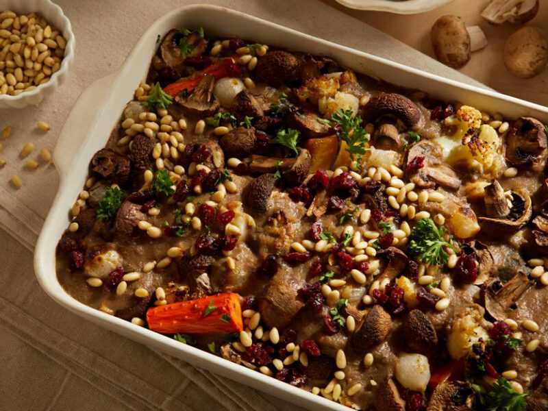 Harvest Vegetable Casserole with Lentils and Gravy in a serving dish