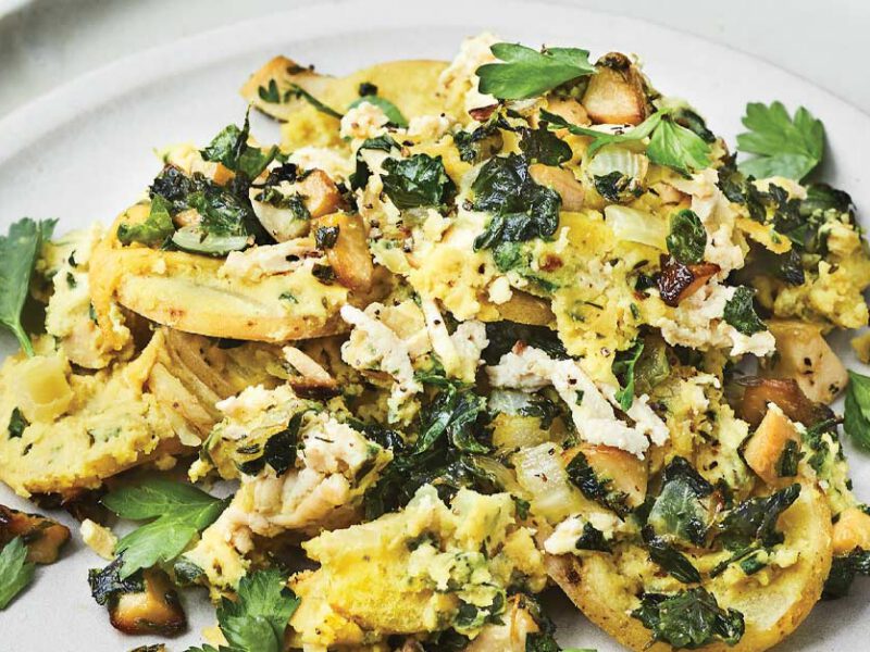 Potato-Spinach Casserole with Trumpet Mushrooms on a white plate