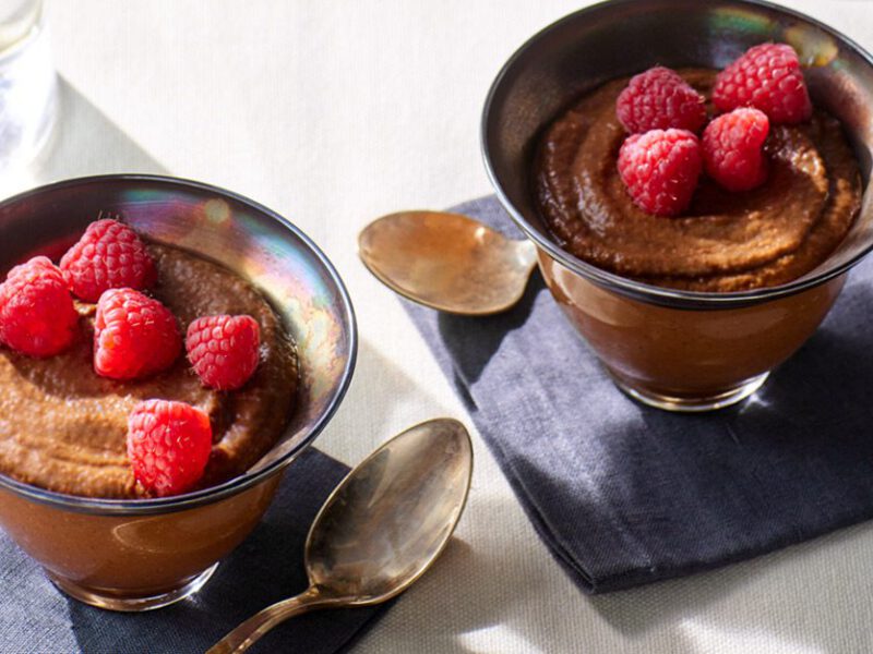 Vegan Chocolate Mousse in a tin bowl topped with raspberries