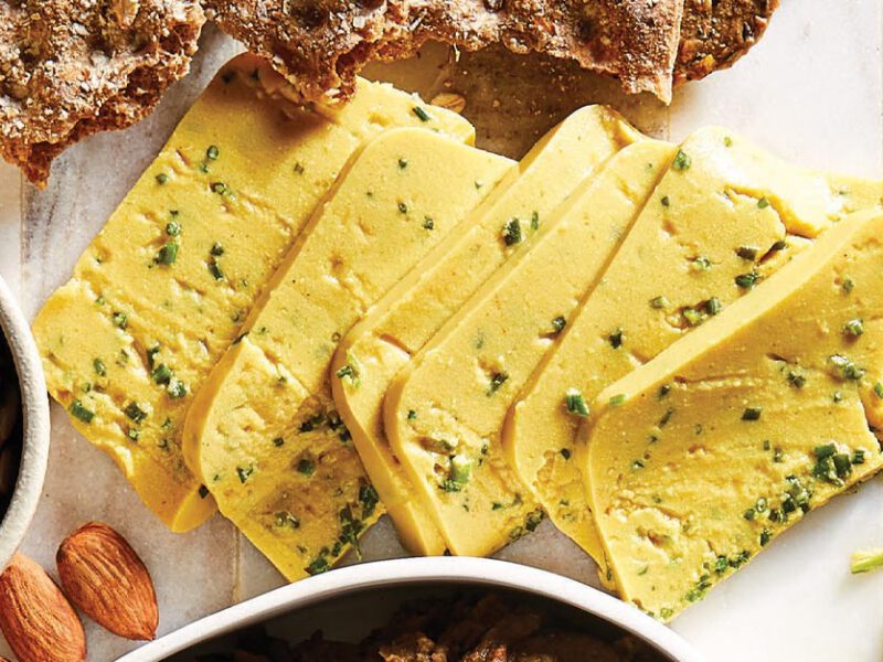 Butternut Vegan Cheddar Cheese with Chives on a charcuterie board