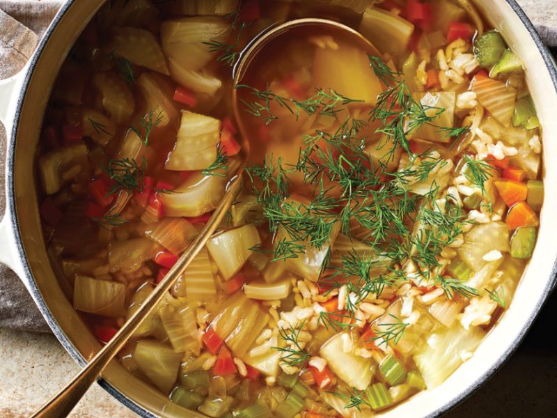 A white pot with handles full of Vegan Chicken and Rice Soup