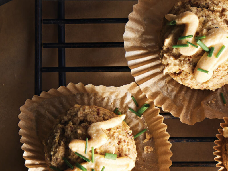 Three Savory Breakfast Muffins with Garlic Cheese Spread in muffin papers, cooling on a baking rack