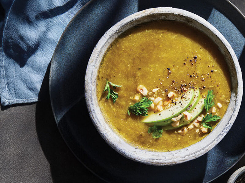 Leek, Apple, and Hazelnut Soup garnished with sliced apple, toasted hazelnuts, and fresh parsley