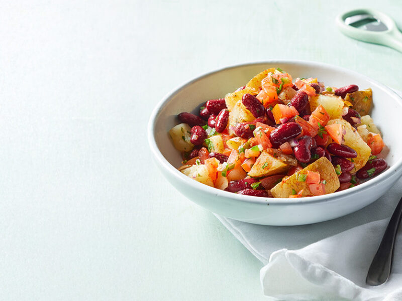 Southwest Potato and Red Bean Bowl against a pale green background
