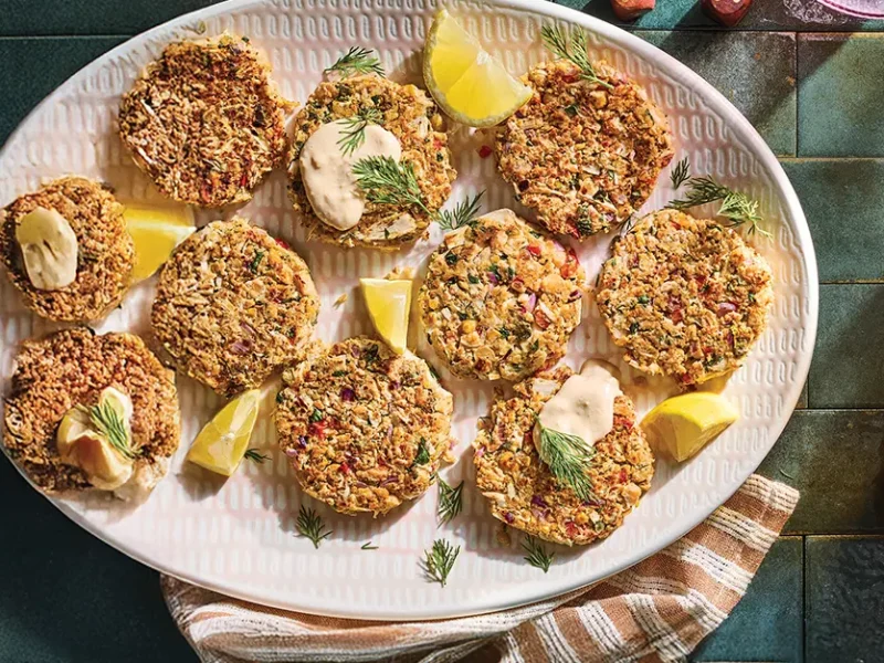 Vegan Crab Cakes on a platter with a small bowl of Remoulade to the side