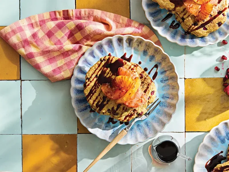 A plate of Pomegranate Pancakes with grapefruit and orange