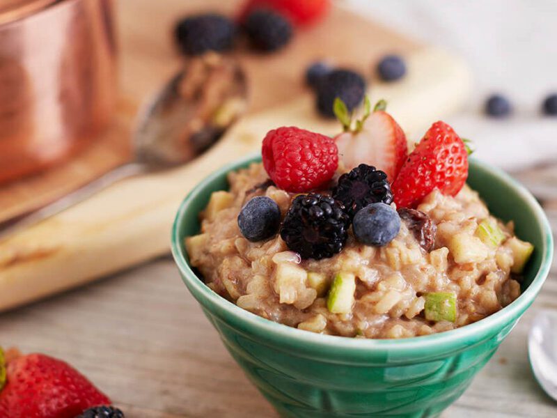 A bowl of brown rice pudding garnished with fresh berries