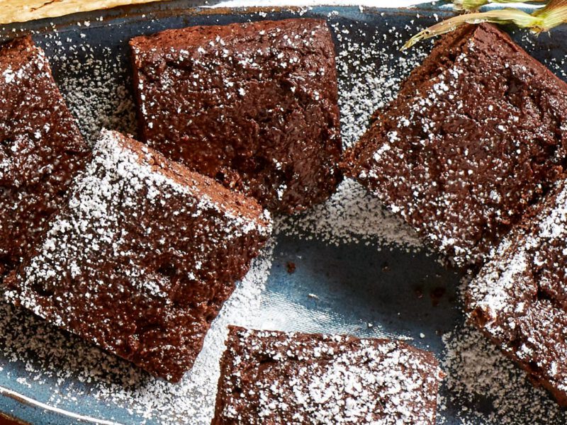 Mexican Chocolate Brownies on a plate, dusted with a light coating of powdered sugar